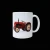 Biały ceramiczny kubek z nadrukiem czerwonego zabytkowego ciągnika rolniczego widocznego z boku. Traktor ma jasne felgi, duże tylne koło i charakterystyczną pionową rurę wydechową. Kubek pokazano na czarnym tle, z uchem po prawej stronie.
